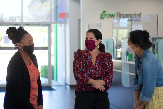 Three Grow team members talk inside a store location