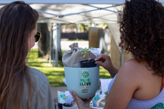 Two women standing with Grow On Us Herb How-To Kit