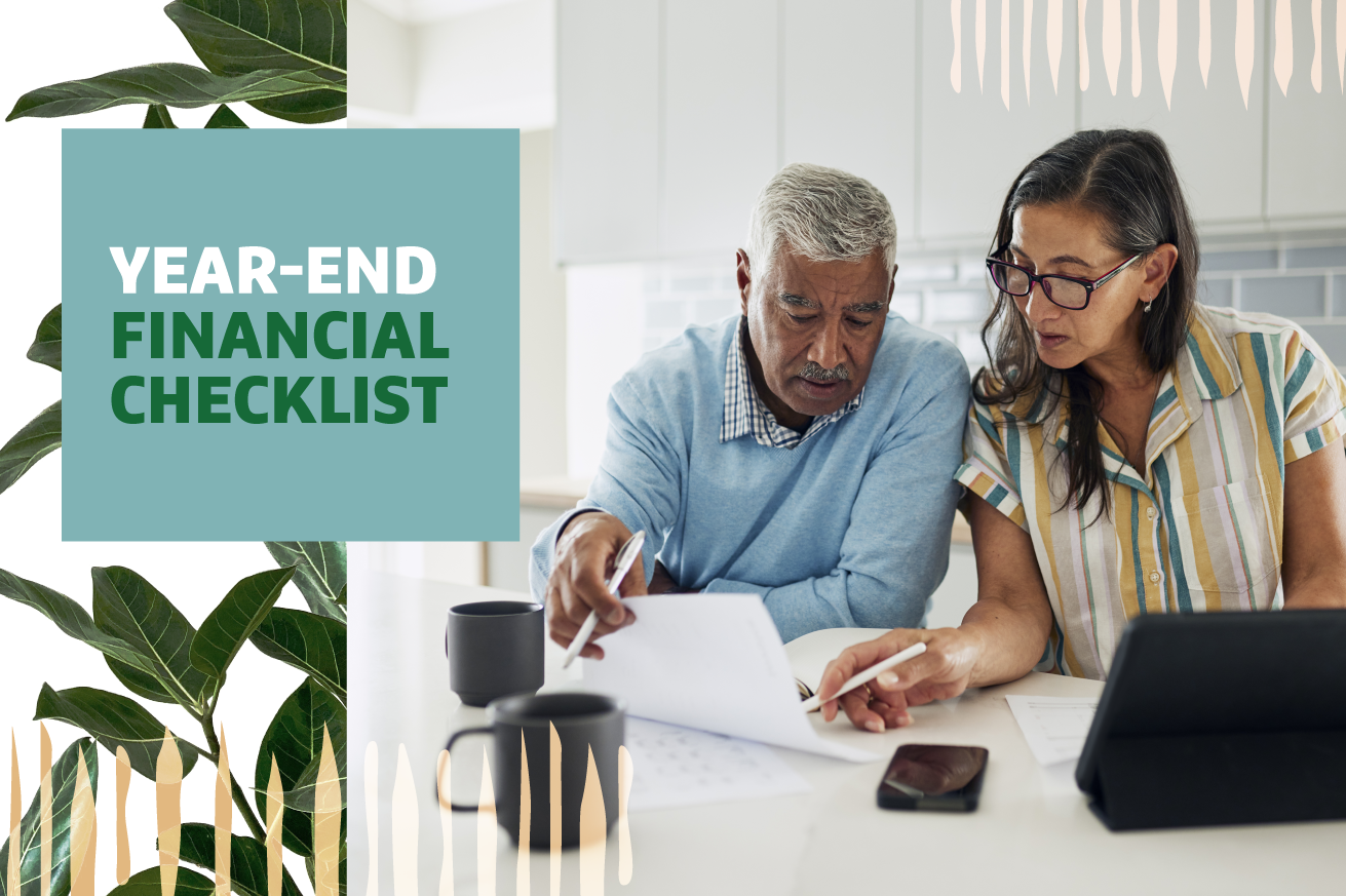 Two individuals reviewing documents at a table with a laptop nearby, with headline text "Year-End Financial Checklist".