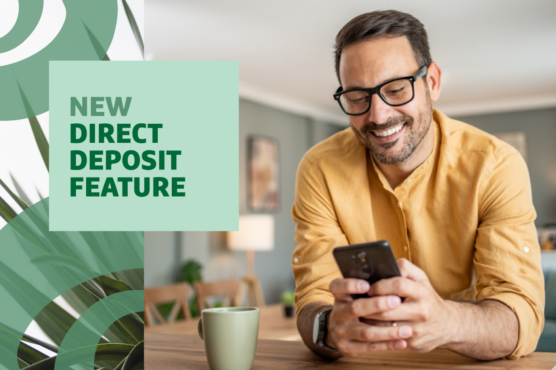 Person smiling while setting up direct deposit on smartphone, sitting at a table with a coffee cup, headline 'NEW DIRECT DEPOSIT FEATURE' overlaid.